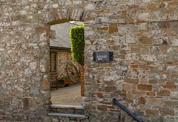 Explore the pretty rose garden courtyard outside this delightful barn conversion.