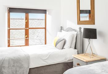 Bedroom 2 has calming grey decor for a relaxing night's slumber.