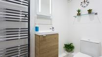 The minimalistic decor and white walls prevent the bathroom from feeling cluttered.