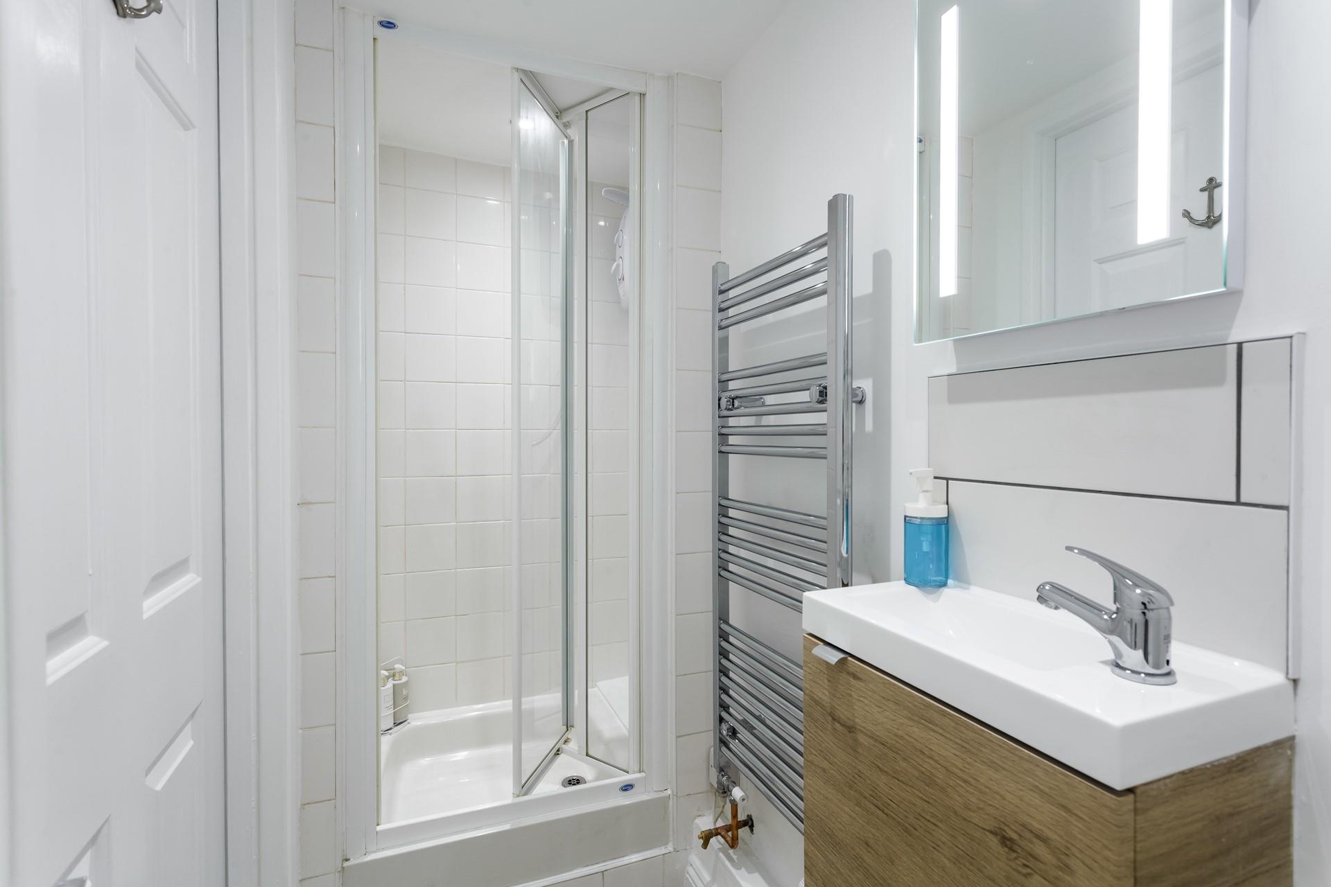 The bathroom is bright and modern, perfect for starting your day with an invigorating shower.