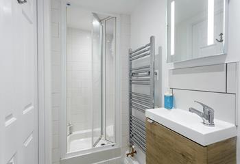 The bathroom is bright and modern, perfect for starting your day with an invigorating shower.