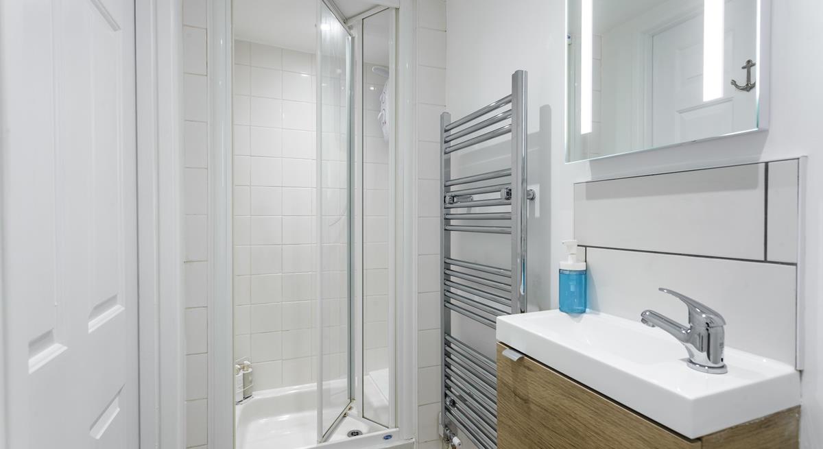 The bathroom is bright and modern, perfect for starting your day with an invigorating shower.