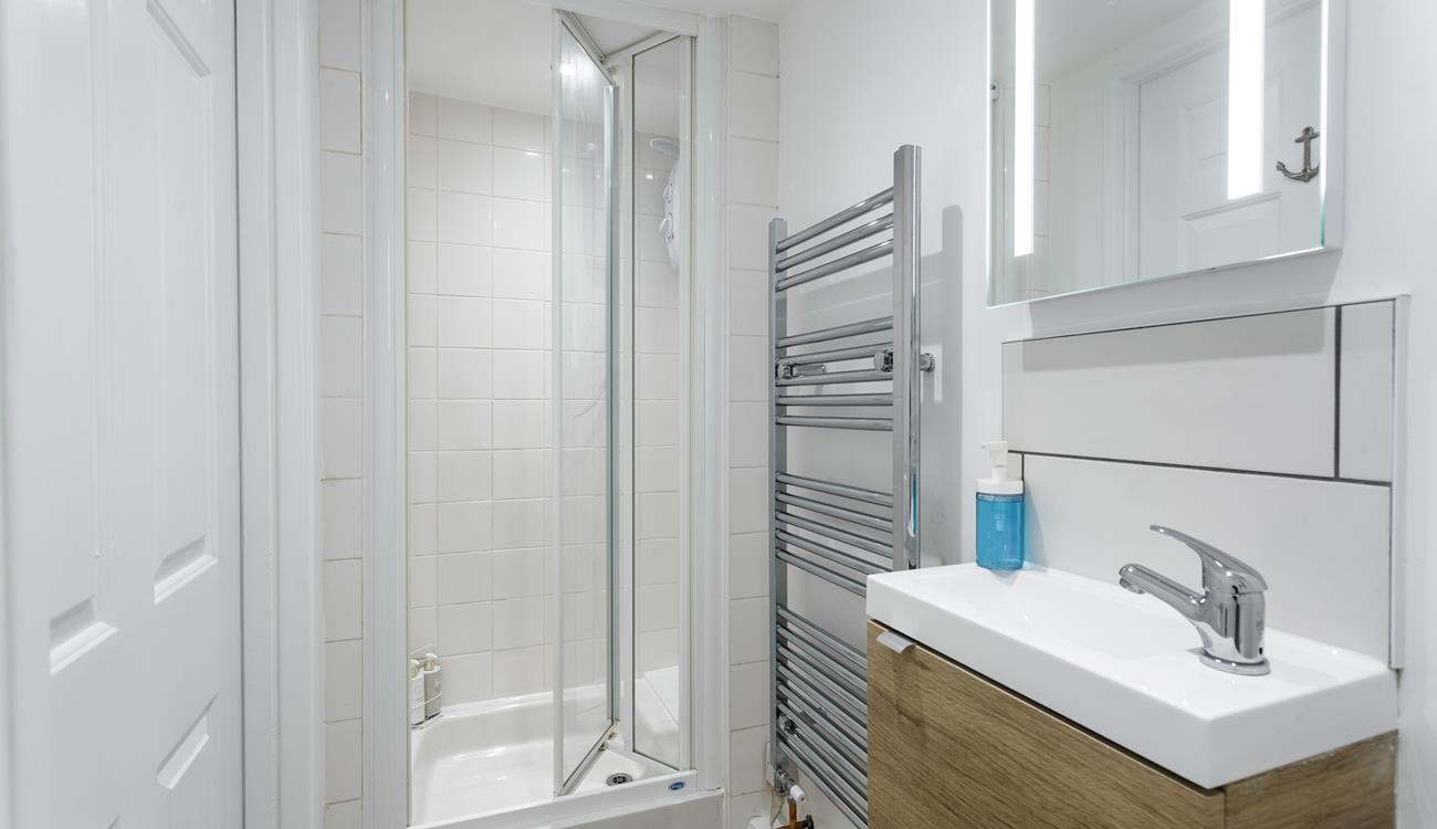 The bathroom is bright and modern, perfect for starting your day with an invigorating shower.