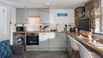 The kitchen is well-equipped with modern appliances making whipping up home-cooked meals a breeze!