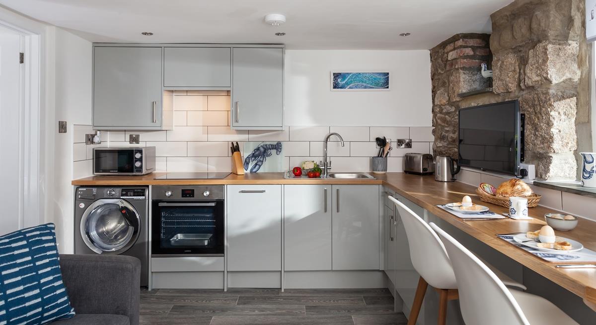 The kitchen is well-equipped with modern appliances making whipping up home-cooked meals a breeze!