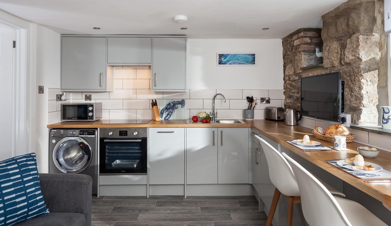 The kitchen is well-equipped with modern appliances making whipping up home-cooked meals a breeze!