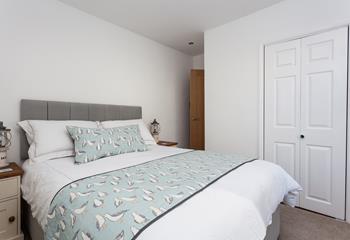 The seaside theme carries into the bedroom with the quirky bedding.