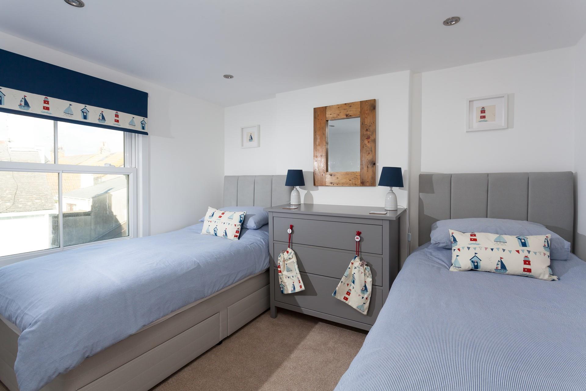 Bedroom 3 has twin beds, perfect for the kids who will be exhausted from a day at the beach.