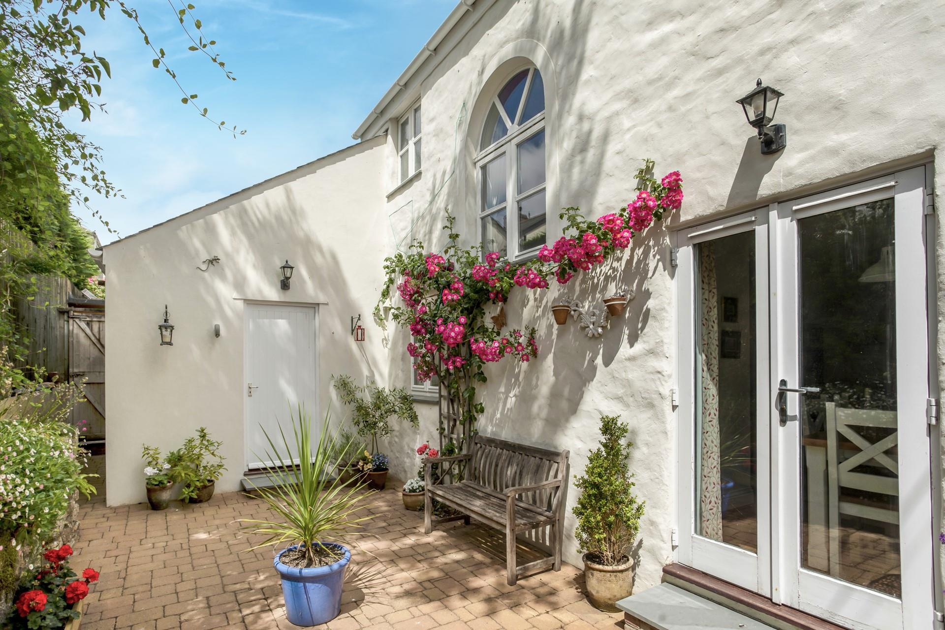 We love the blooming flowers on this cosy cottage.