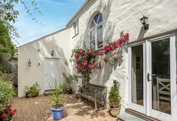 We love the blooming flowers on this cosy cottage.