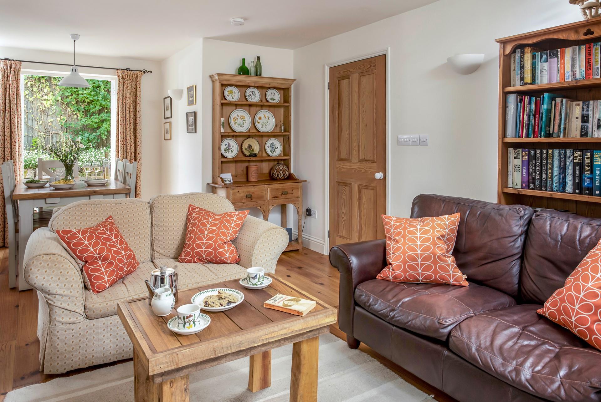 The living area is off the hallway, next to the kitchen, and provides plush furnishings.