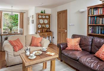 The living area is off the hallway, next to the kitchen, and provides plush furnishings.