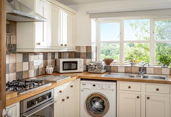 The kitchens charming style and modern appliances make it a joy to cook in.