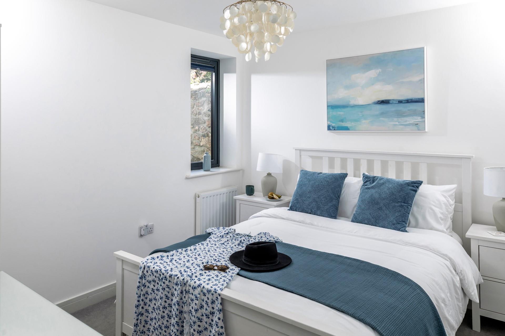 Bedroom 3 has a comfortable king size bed and beautiful coastal artwork.