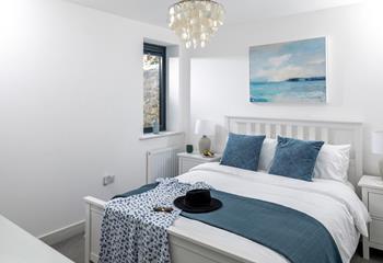 Bedroom 3 has a comfortable king size bed and beautiful coastal artwork.