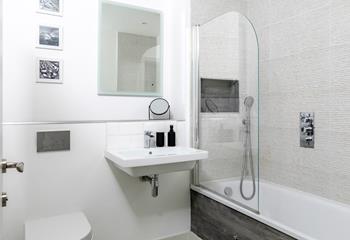 The spacious family bathroom has a bath with handy shower attachment, great for holidaying with little ones.