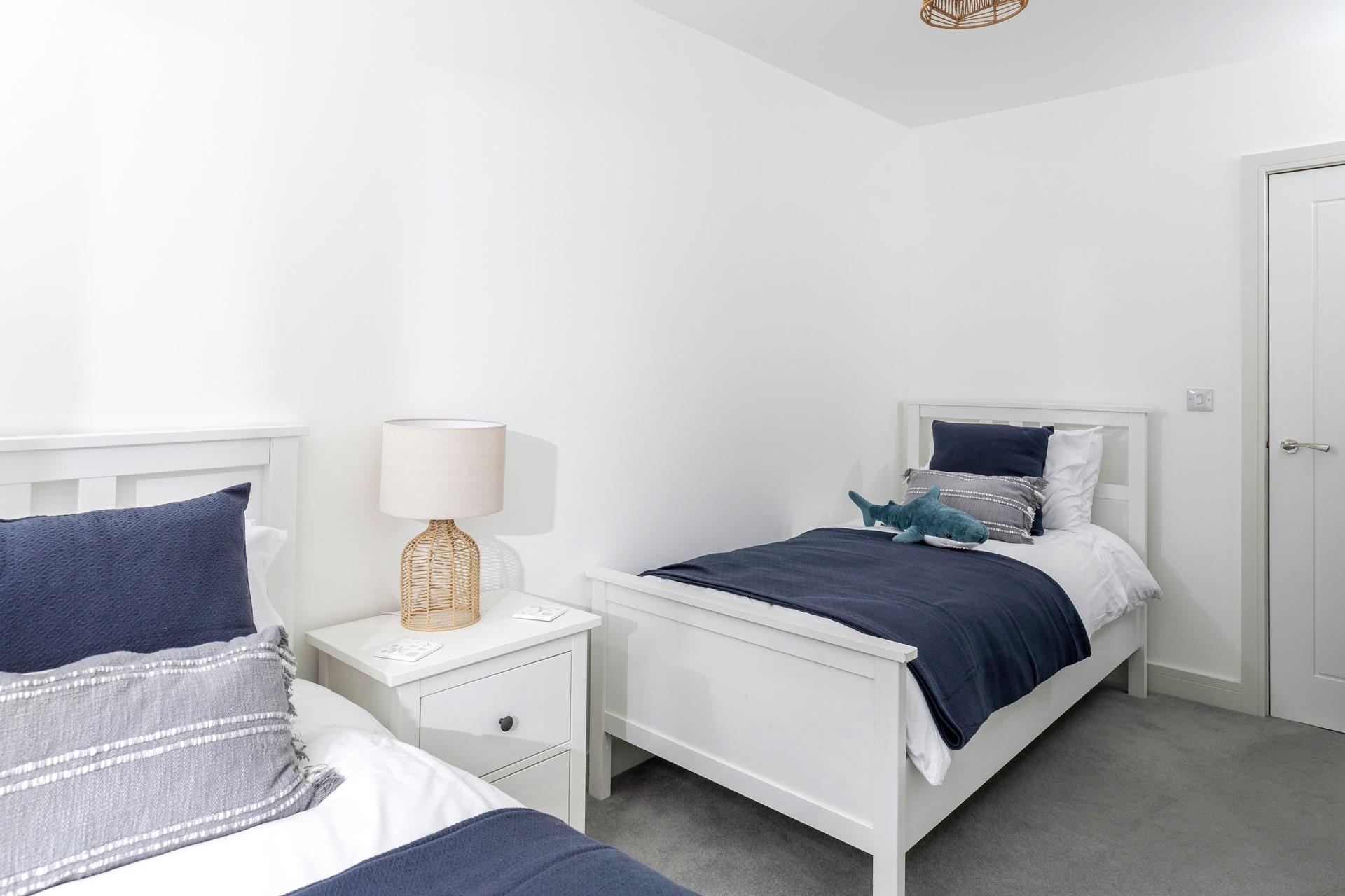 Comfortable twin beds await after a day on the beach.