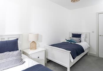 Comfortable twin beds await after a day on the beach.