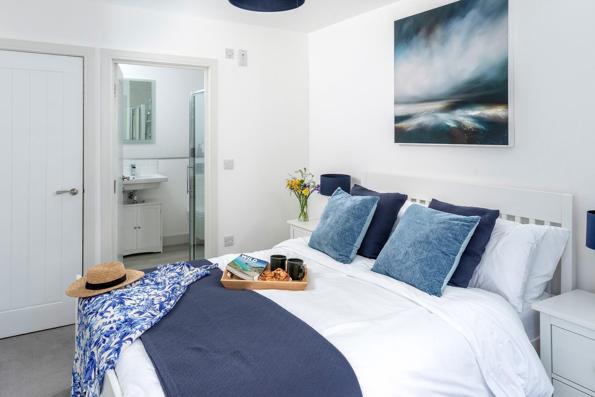 Bedroom 2 is a coastal sanctuary with a king size bed and an en suite shower room.