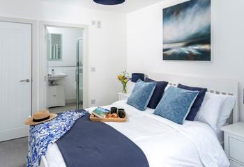 Bedroom 2 is a coastal sanctuary with a king size bed and an en suite shower room.