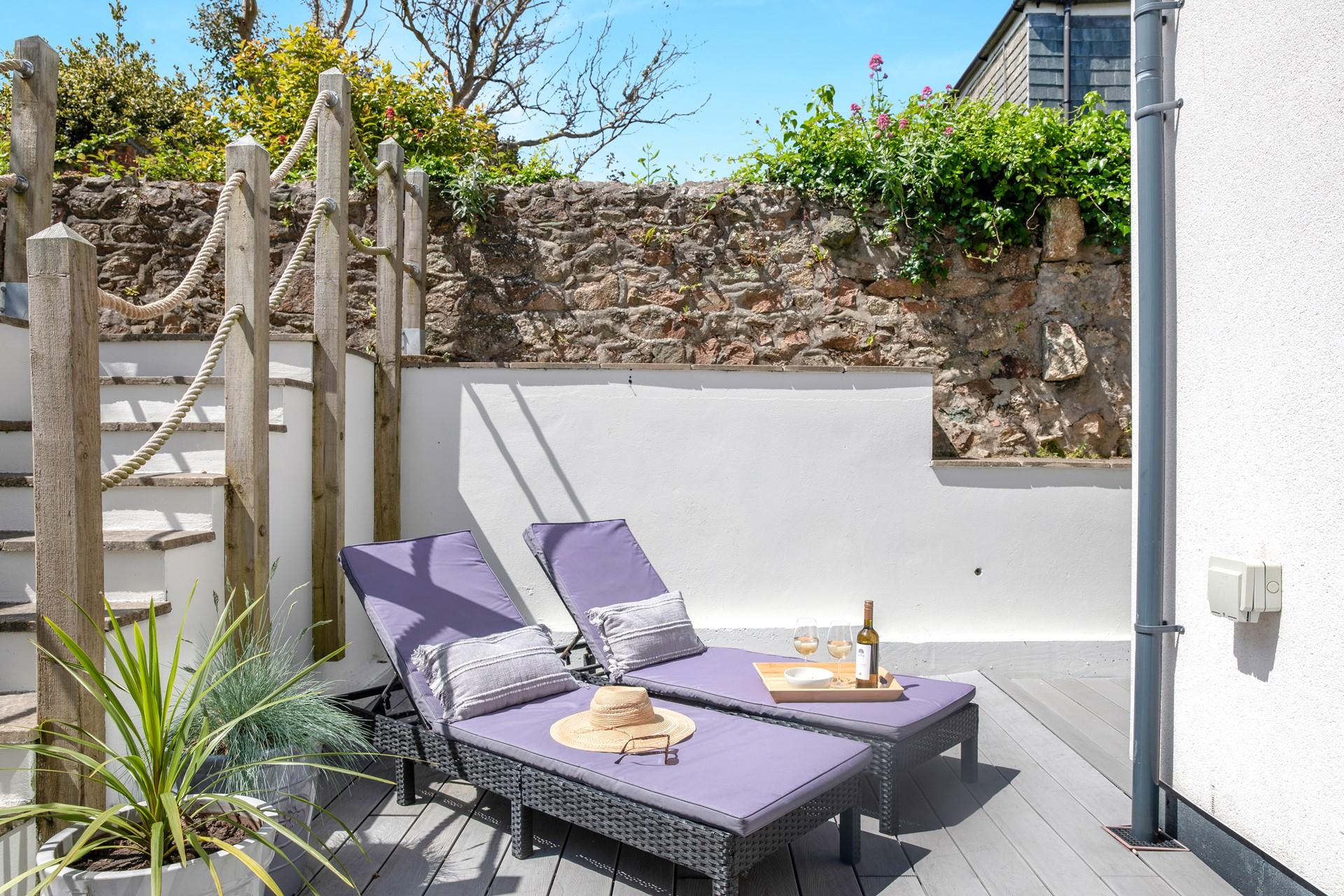 The split level courtyard is a tranquil spot, with loungers for relaxing in the sunshine.