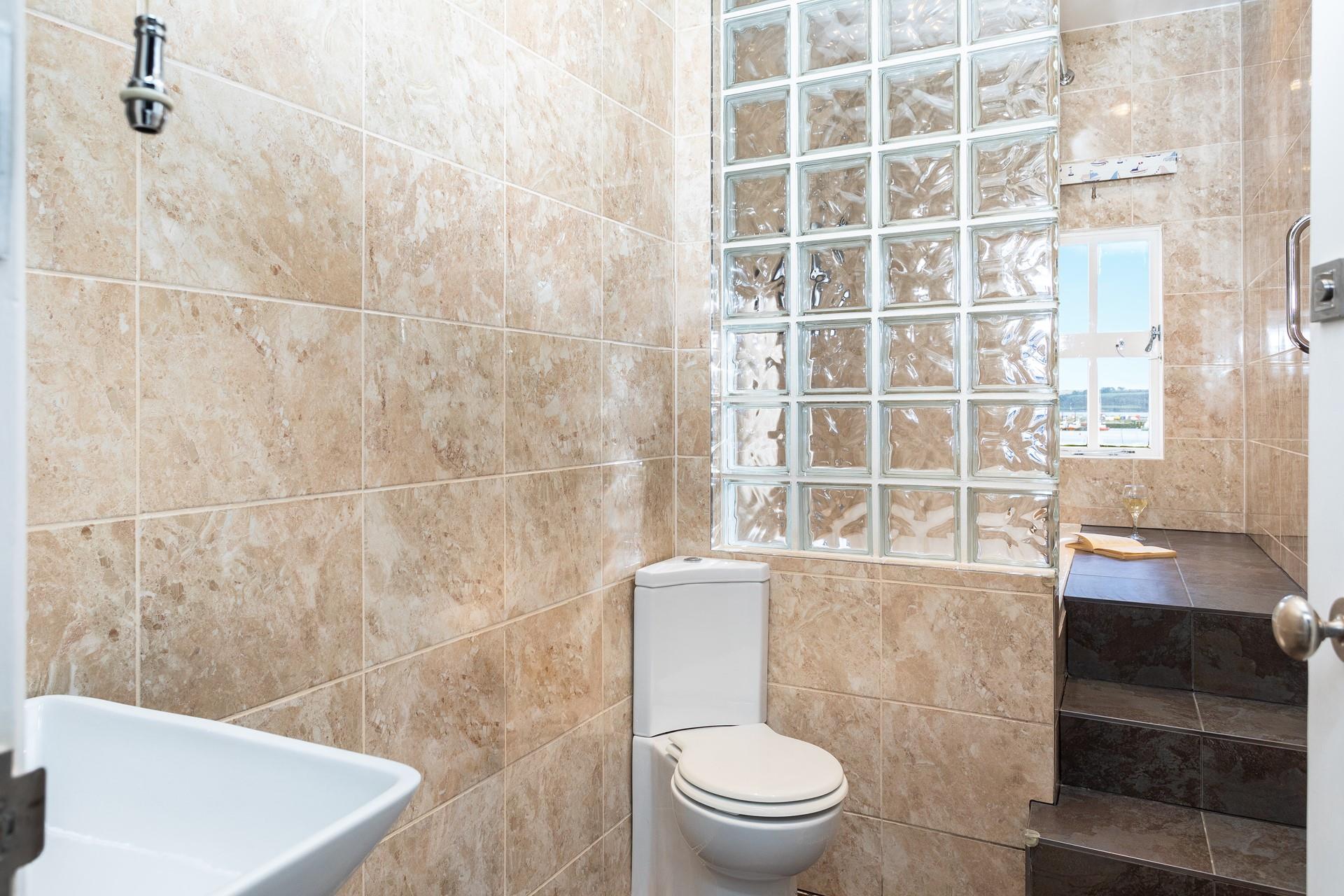 Steps up to the bath add an extra touch of luxury to the bathroom.