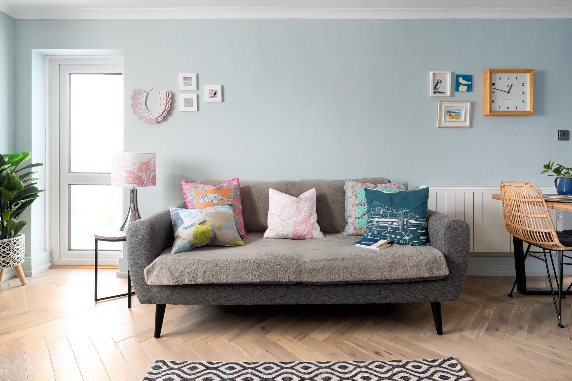 Cool greys and blues create a calming, coastal atmosphere in the sitting room.
