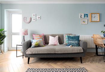 Cool greys and blues create a calming, coastal atmosphere in the sitting room.