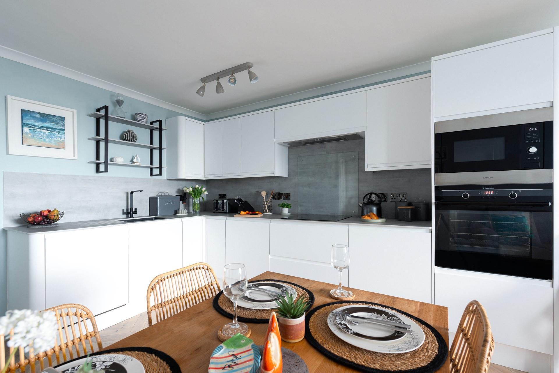 The modern kitchen is well-equipped for the chef of the family to rustle up a tasty meal.