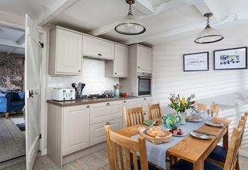 The kitchen has been finished to a high standard, with stylish lighting and Cornish artwork. 