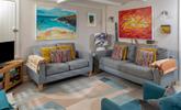 The sitting room perfectly combines traditional features with modern and colourful decor. - Thumbnail Image