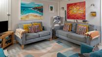 The sitting room perfectly combines traditional features with modern and colourful decor.