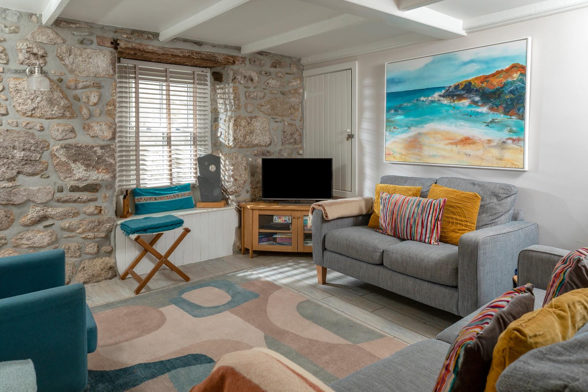 Surprisingly bright and spacious for an old fisherman's cottage, the sitting room is inviting and relaxing.