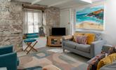 Surprisingly bright and spacious for an old fisherman's cottage, the sitting room is inviting and relaxing. - Thumbnail Image