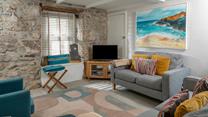 Surprisingly bright and spacious for an old fisherman's cottage, the sitting room is inviting and relaxing.