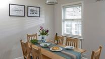 Gather together at the dining table to enjoy an afternoon treat before heading back to the beach!