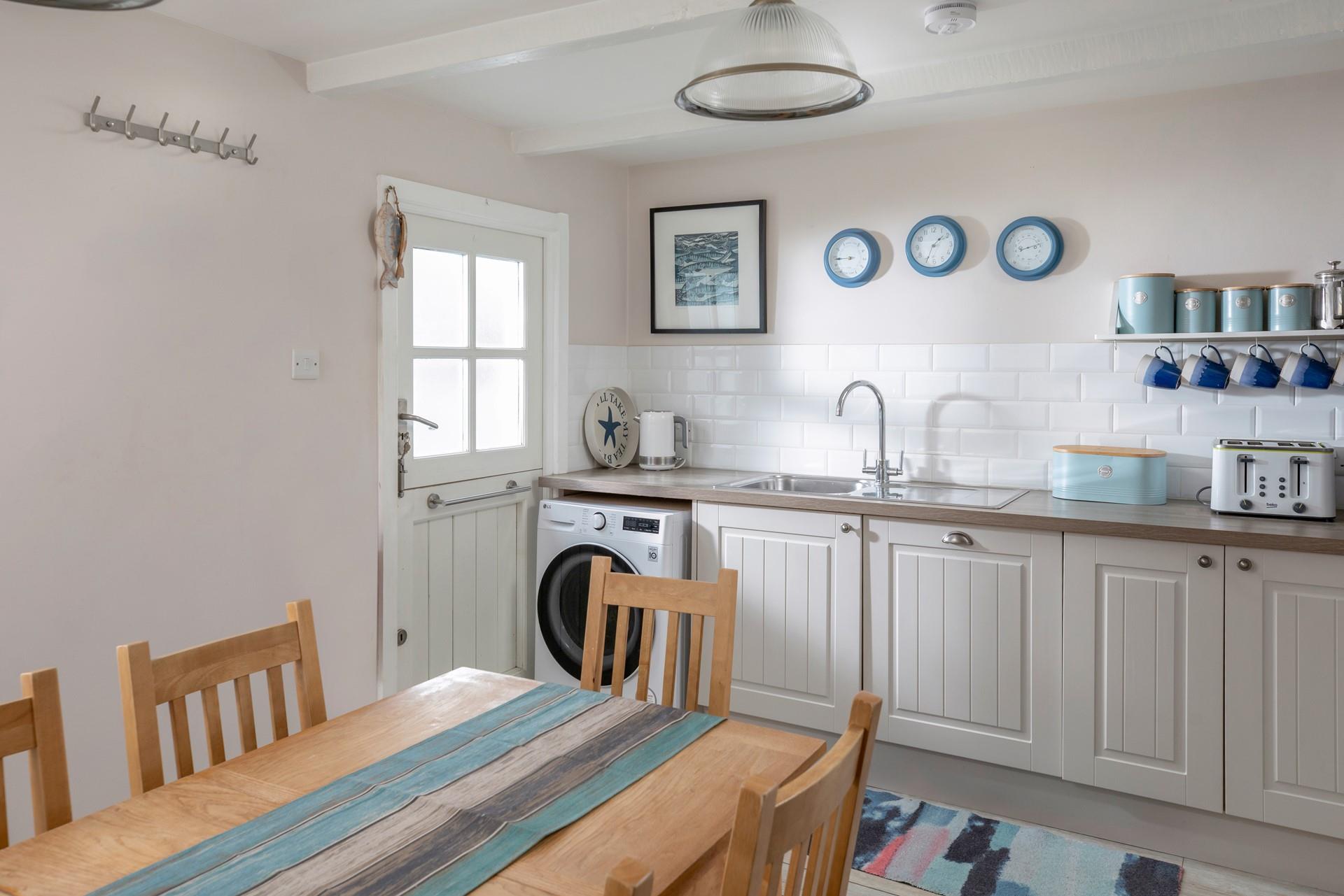 The kitchen has been finished to a high standard, with stylish lighting and Cornish artwork. 