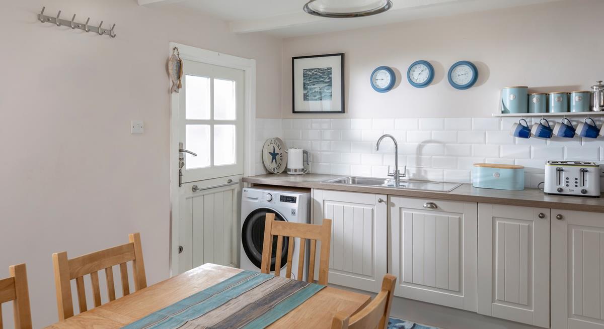 The kitchen has been finished to a high standard, with stylish lighting and Cornish artwork. 