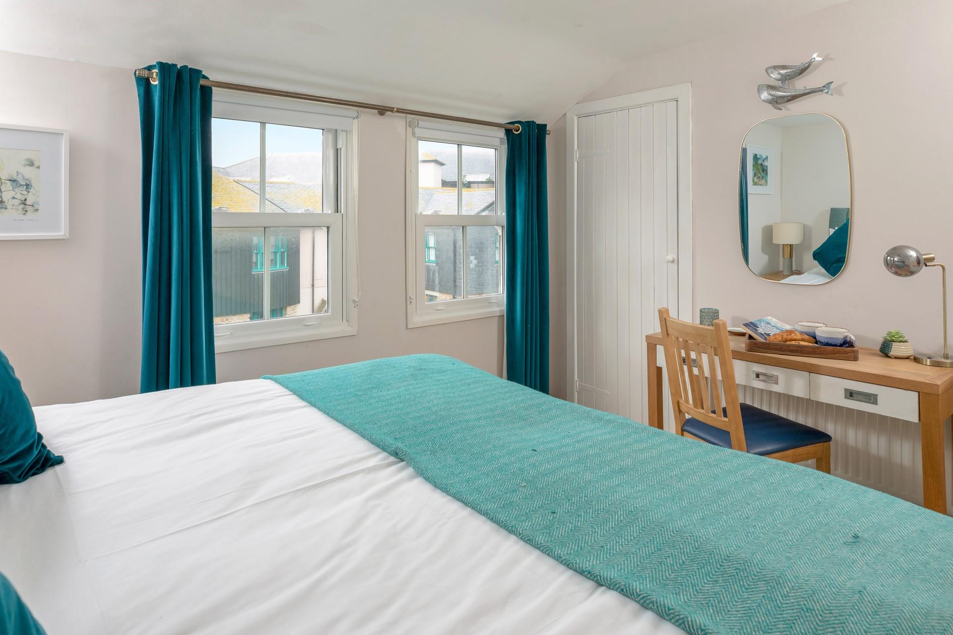 Dual windows allow plenty of natural light to fill bedroom 1.
