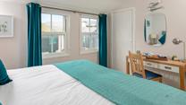 Dual windows allow plenty of natural light to fill bedroom 1.