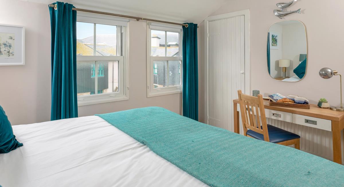 Dual windows allow plenty of natural light to fill bedroom 1.