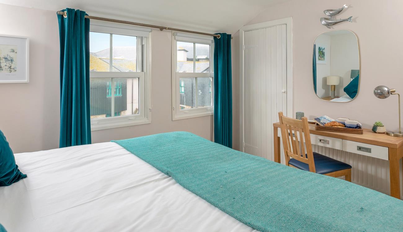 Dual windows allow plenty of natural light to fill bedroom 1.