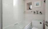 Pure whites create a relaxing space for unwinding in the bath at the end of a busy day.  - Thumbnail Image