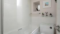 Pure whites create a relaxing space for unwinding in the bath at the end of a busy day. 