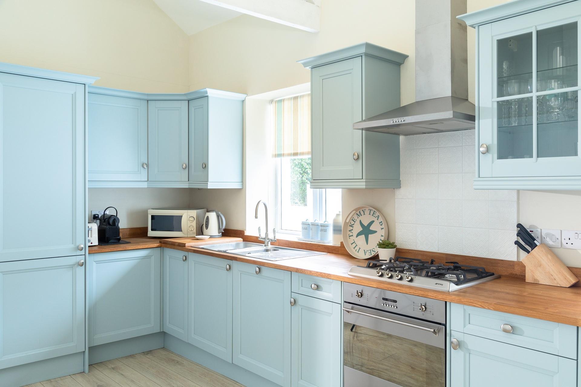 The pastel blue kitchen is perfect for the chef of the family to rustle up delicious meals.