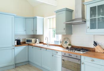 The pastel blue kitchen is perfect for the chef of the family to rustle up delicious meals.