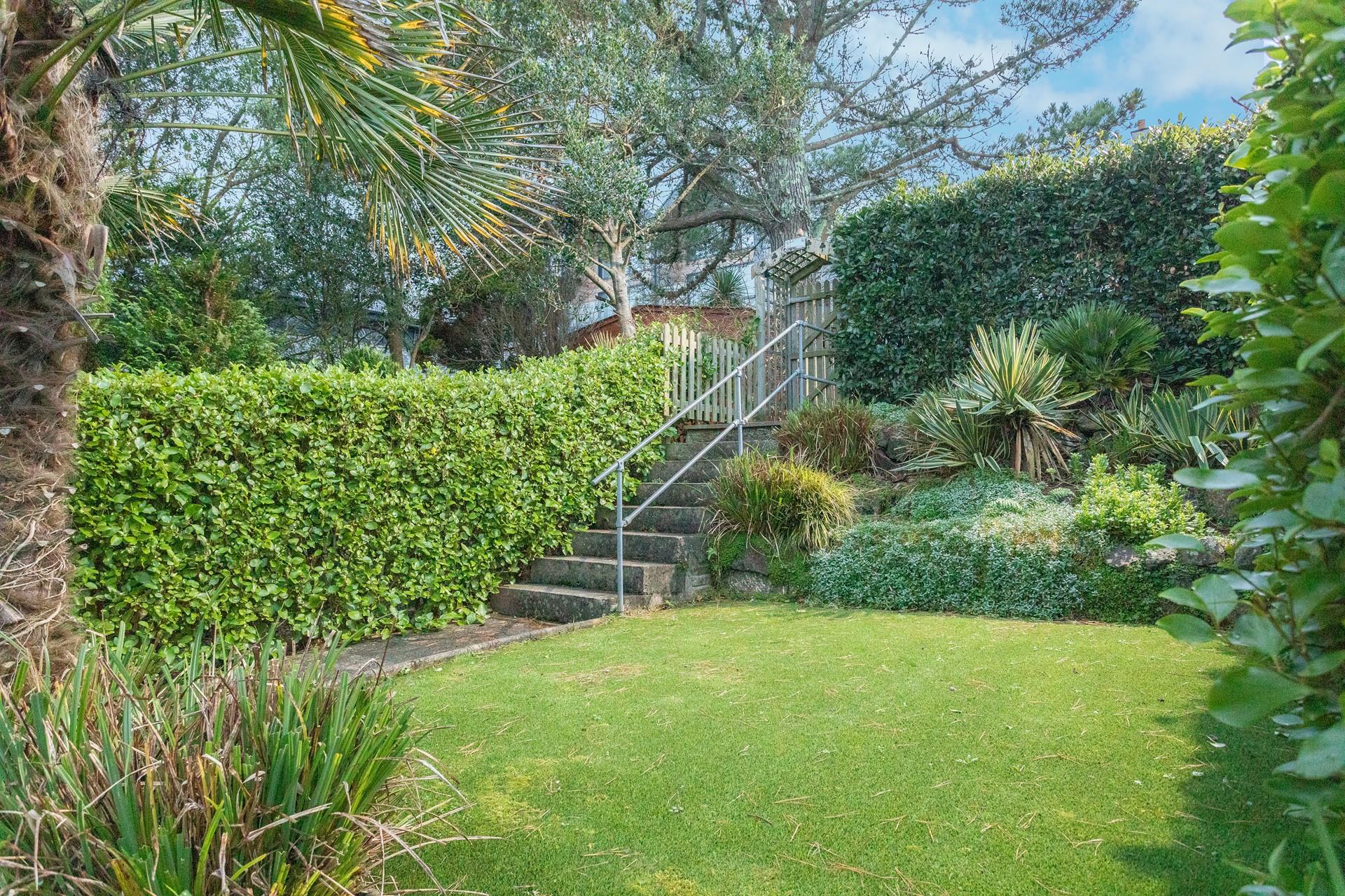 Soak up the last of the evening sun in the garden with a glass of wine in hand.