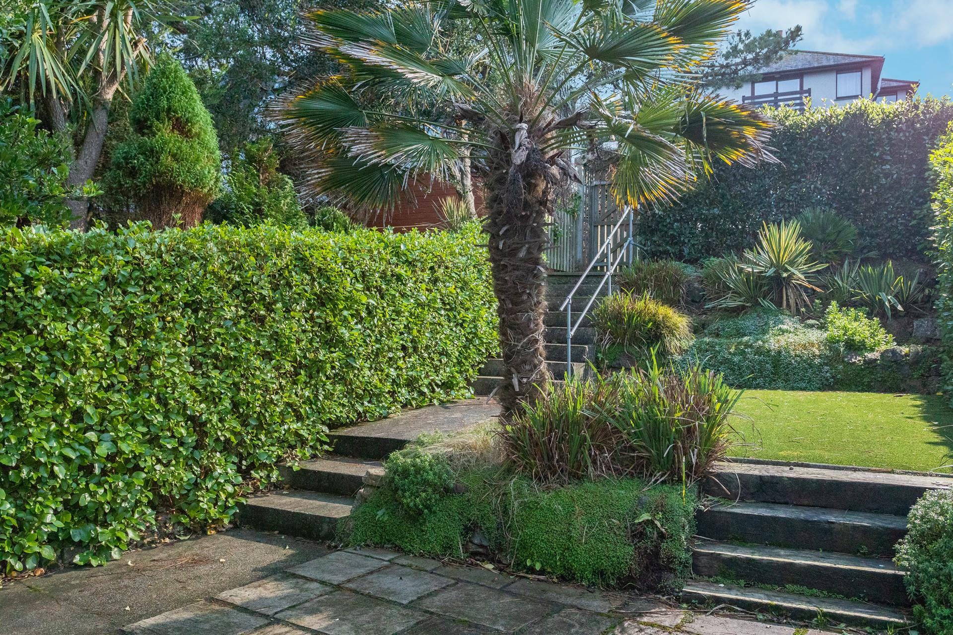 The outside area offers a patio area for dining and artificial turf, perfect for the kids to play. 