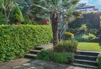 The outside area offers a patio area for dining and artificial turf, perfect for the kids to play. 