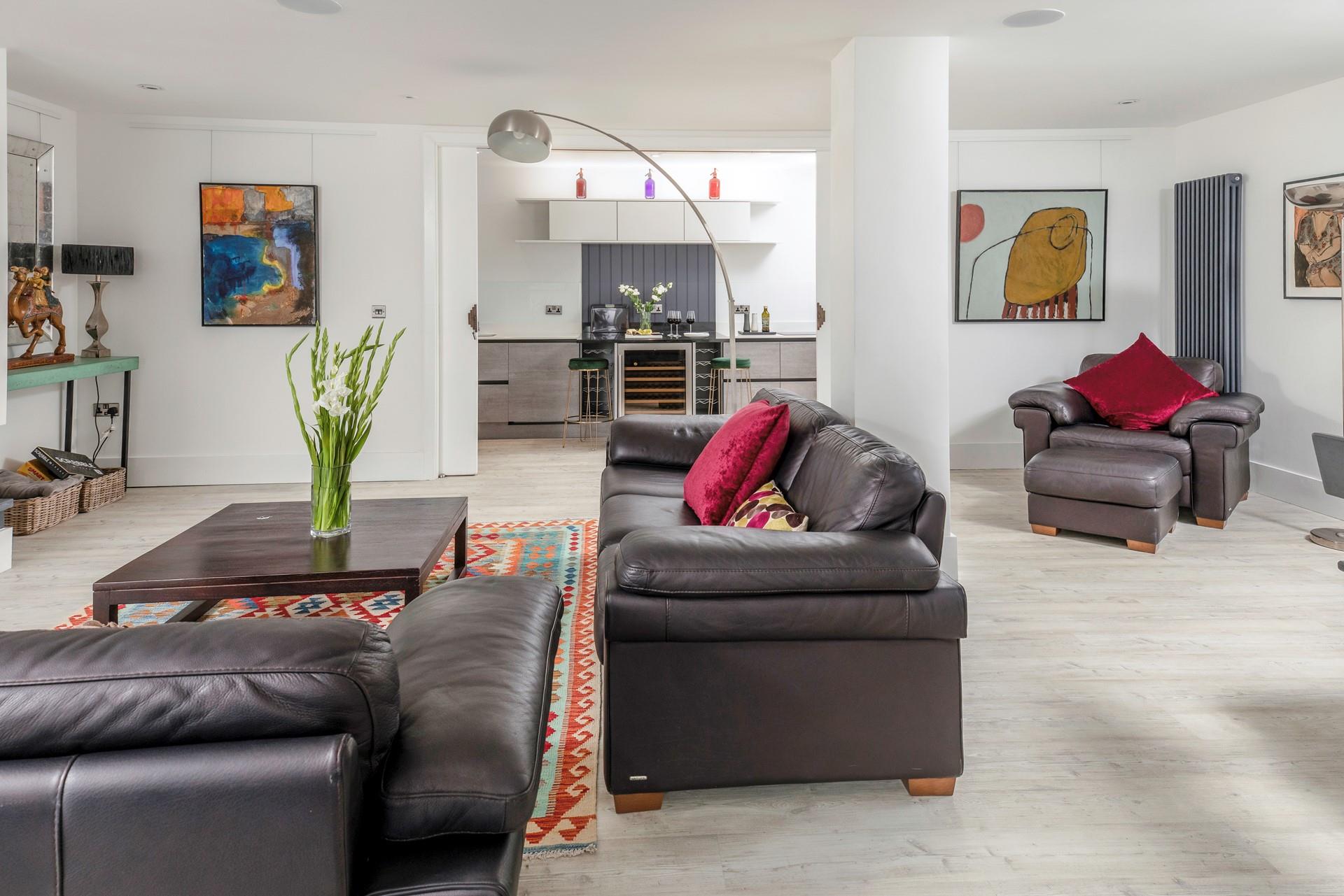 Slide open doors reveal the well-equipped kitchen complete with a wine fridge.